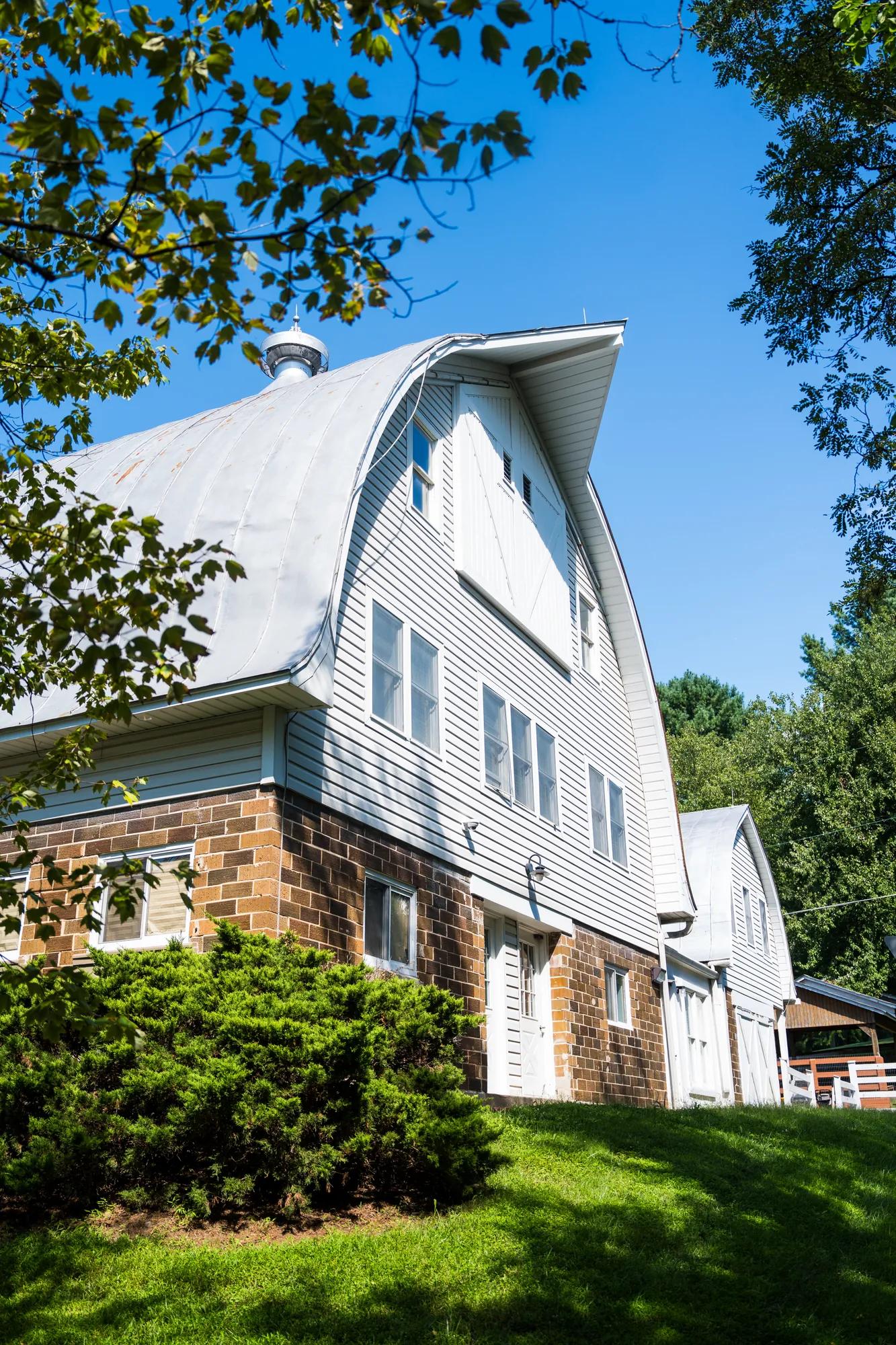 The school's barn-style building seen from the lawn