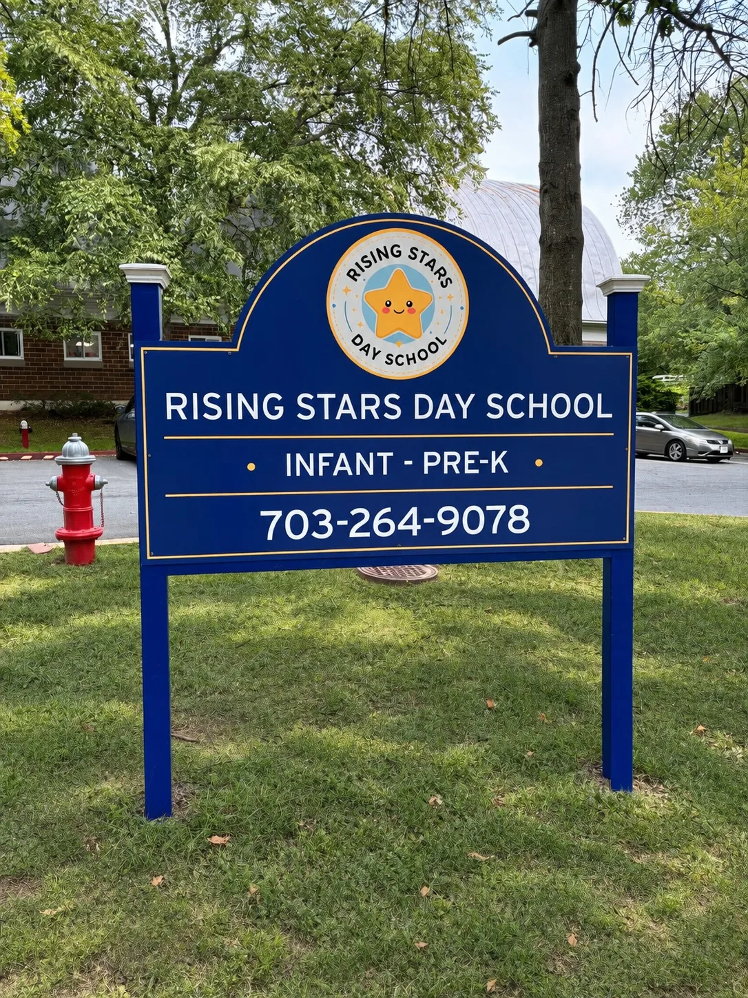 The Rising Stars Day School sign at the road